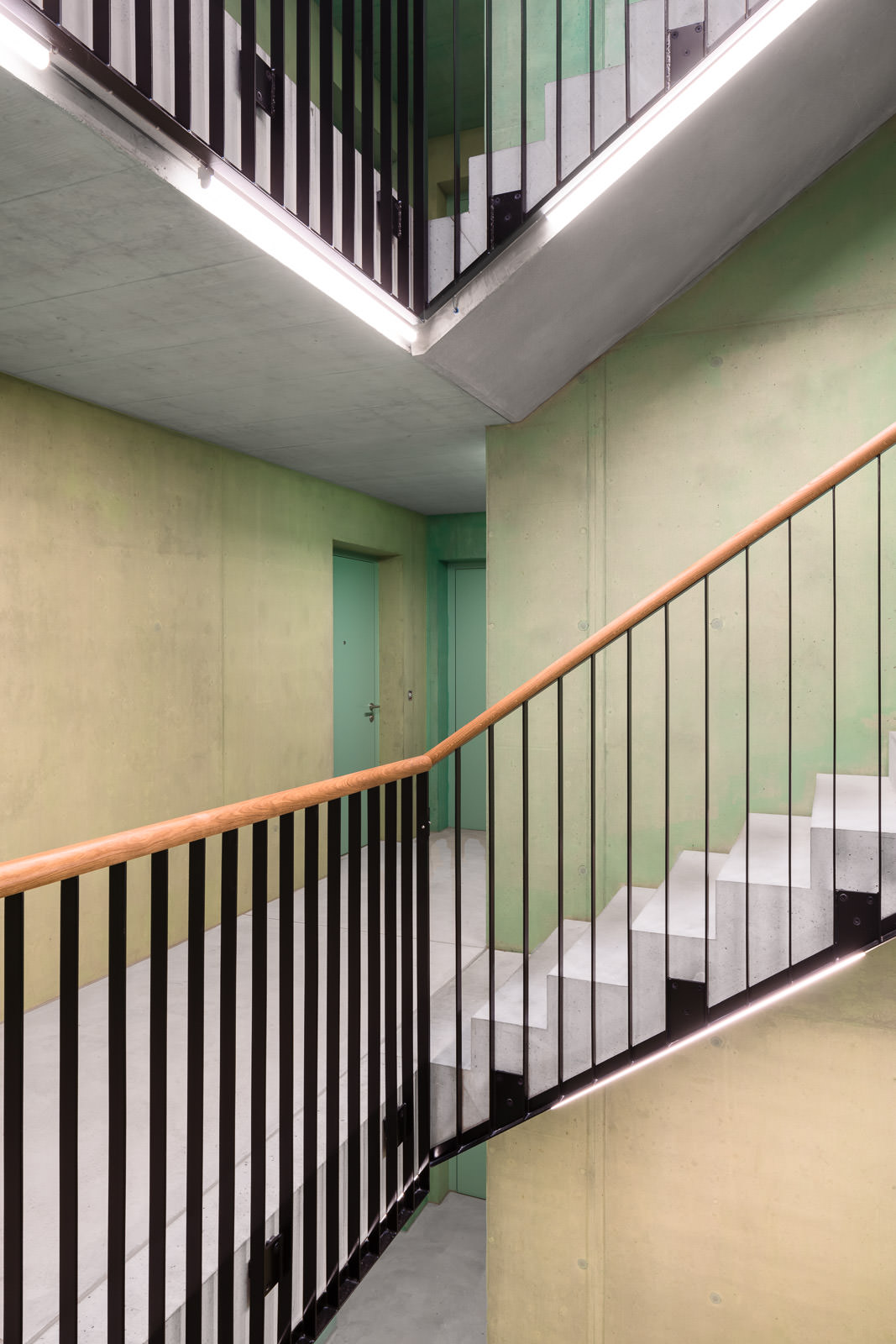 Staircase, green, concrete walls, metal frame, wooden grip - Architecture Photography Zurich