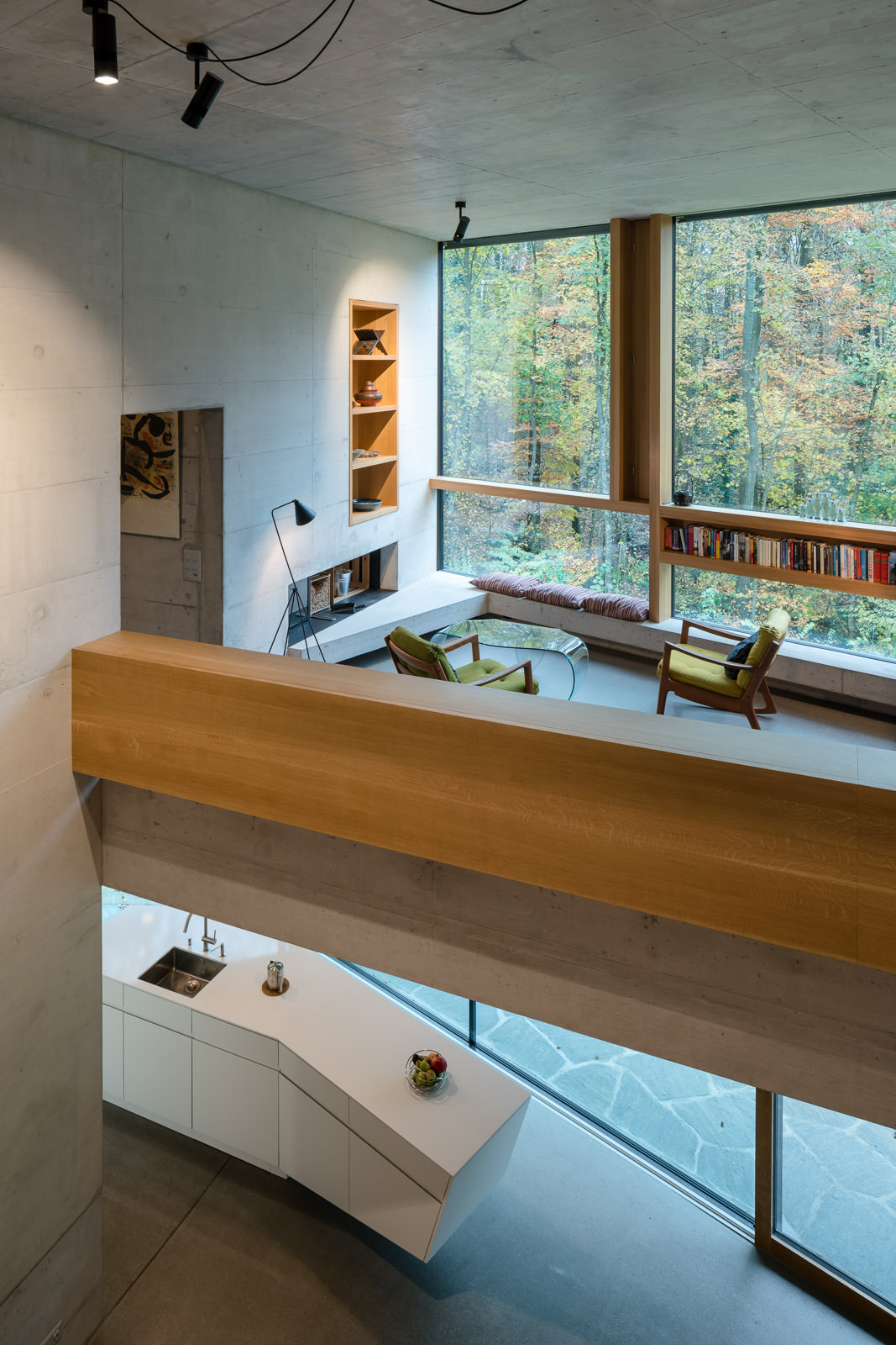 Living room and kitchen of casa forest with forest view. Architectural Photography