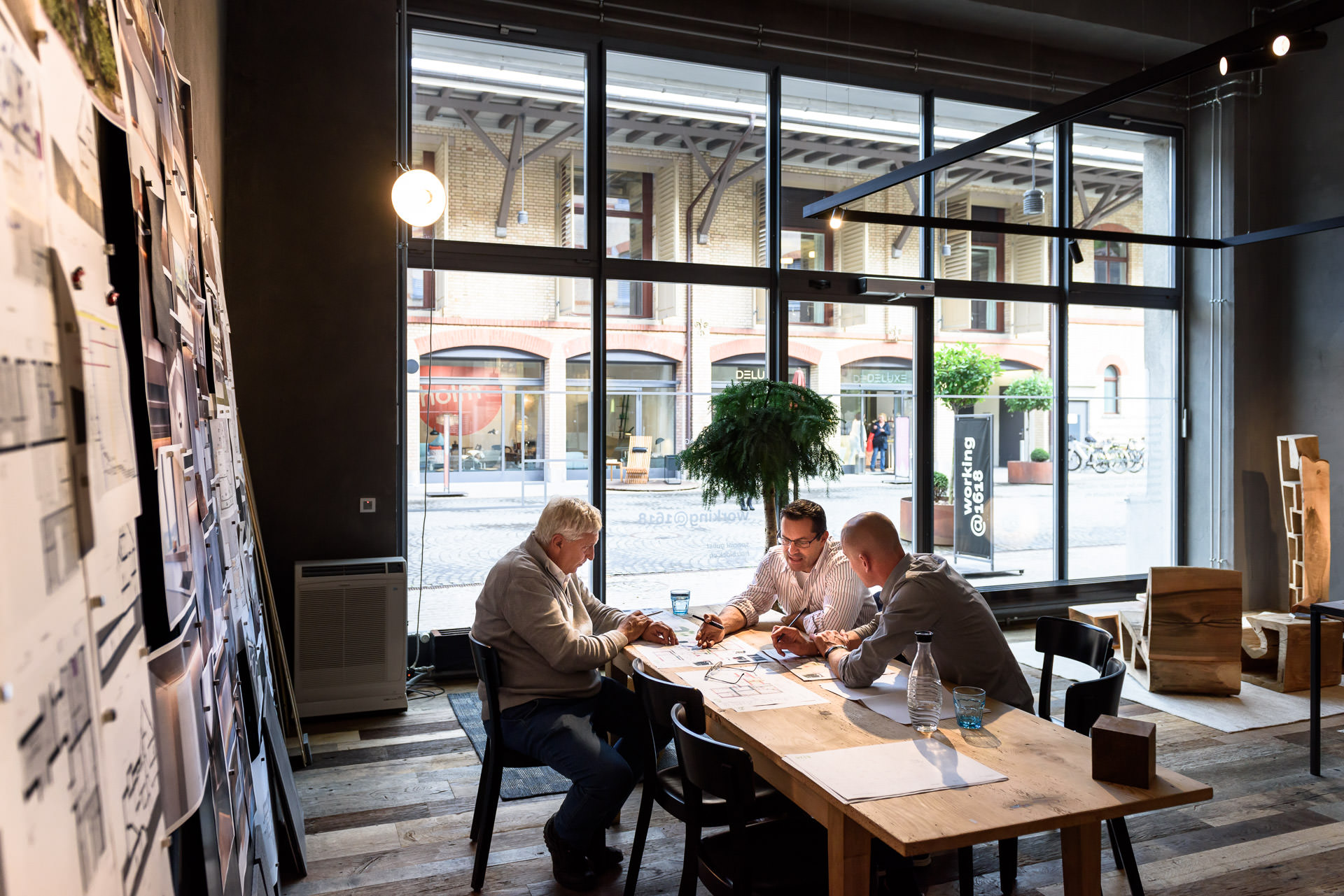 Meeting of real estate developer with architect in a stylish industrial style office.